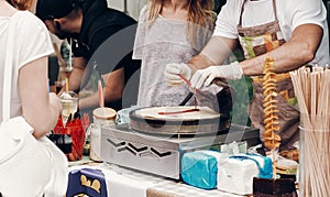 man making pancakes at street food festival. chef cooking french