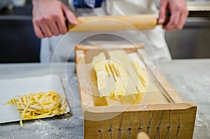 Man making pasta alla chitarra