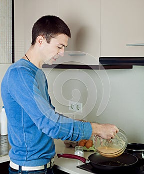 Man making scrambled eggs