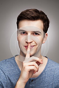 Man making silence gesture