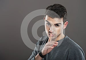 Man making a silence gesture