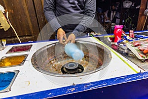 Man making spun sugar, cotton candy, at a shop on El Moez street in Old Cairo photo