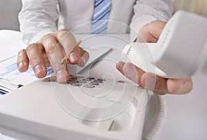 Man making a telephone call on a landline