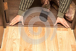 A man is making a threshold on the floor