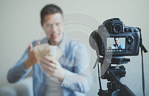 Man making video blog about money earning.