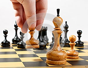 Man making the white pawn move in a chess game