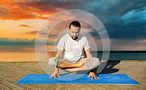 Man making yoga in scale pose outdoors