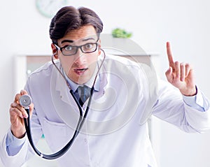 Man male pediatrician near baby bed preparing to examine