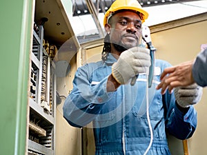 Man male person people black south african wear yellow orange color hardhat blue uniform technical employee