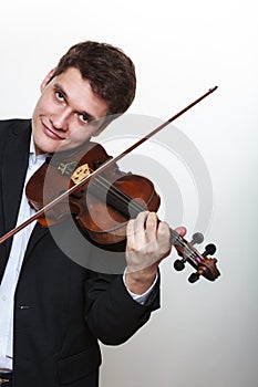 Man man dressed elegantly playing violin