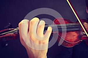 Man man dressed elegantly playing violin