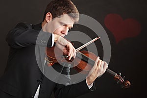 Man man dressed elegantly playing violin