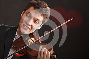 Man man dressed elegantly playing violin