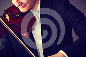 Man man dressed elegantly playing violin