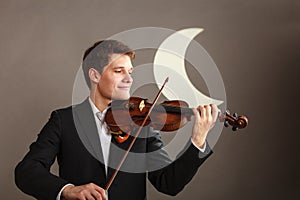 Man man dressed elegantly playing violin