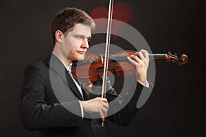 Man man dressed elegantly playing violin