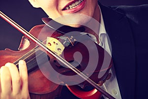 Man man dressed elegantly playing violin