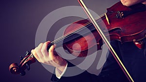 Man man dressed elegantly playing violin