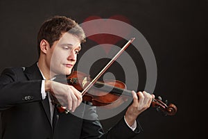 Man man dressed elegantly playing violin