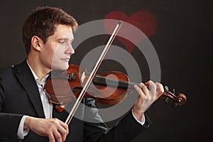 Man man dressed elegantly playing violin