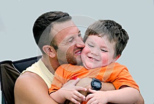 Man Man hugging laughing little boy