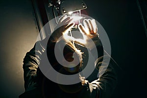 Man manipulating spot light with gloves in production studio