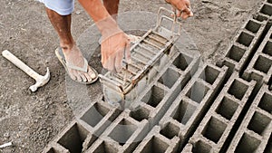 Man manually produces brick molds for construction from volcanic ash in the city of Legazpi. Philippines.