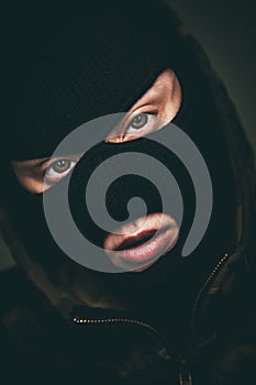 Man in a mask on black background.