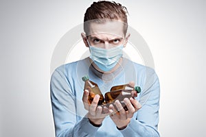 Man in mask holds medicine bottles. Epidemia Coronavirus. Covid -19 photo
