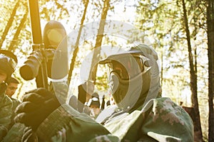 A man in mask for paintball with gun