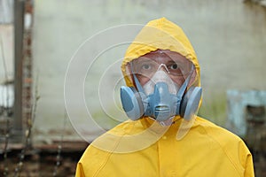 Man with mask and protective clothes explores danger area r