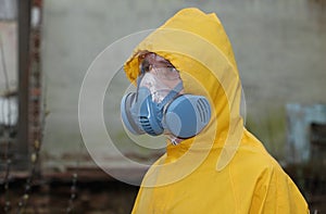 Man with mask and protective clothes explores danger area r