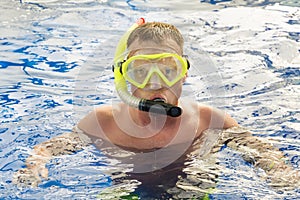 Man with mask snorkeling in clear water. pool