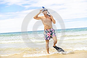 Man with mask for snorkling at the seaside beach