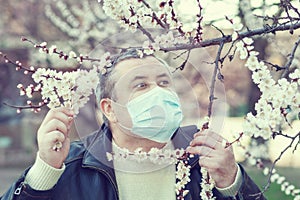 Man in a mask standing on the street