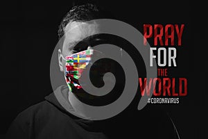 Man with mask for virus protection with text Pray for the World corona virus covid-19