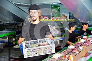 Man in mask working at mango warehouse