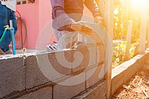 Man masoners constructing masonry to build fences photo