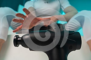 Man with massage percussion device