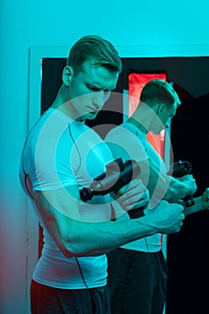 Man with massage percussion device