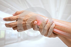 Man massaging painful wrist