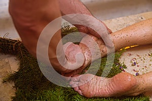 A man massaging a woman& x27;s legs in a hammam