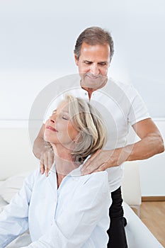 Man massaging woman's shoulder