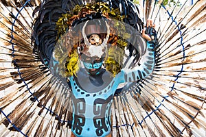 Man in a Mayan warrior costume.