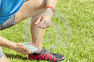 Man on meadow checks his fitness data