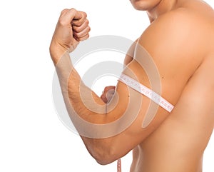 Man measuring biceps with centimeter