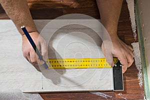 Man measuring floor panels