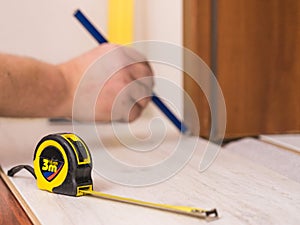 Man measuring floor panels