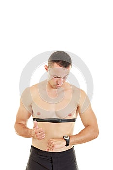 Man measuring heart beat and pulse with chest strap