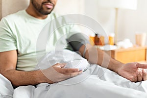 Man measuring his blood pressure at home